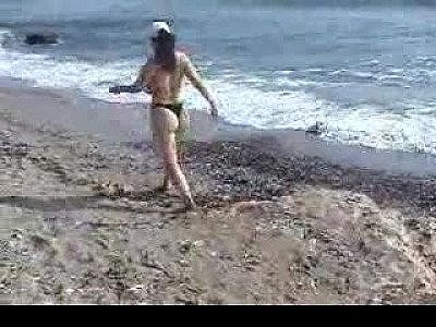 Woman at the beach showing big tits